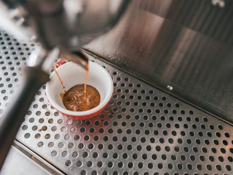 Close up view of preparing coffee espresso in automatic coffee machine in cafe. High quality photo